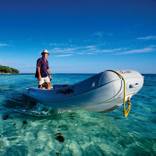 person in inflatable boat on blue water