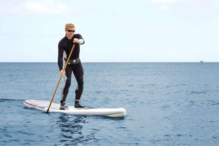 man paddleboarding on calm sea