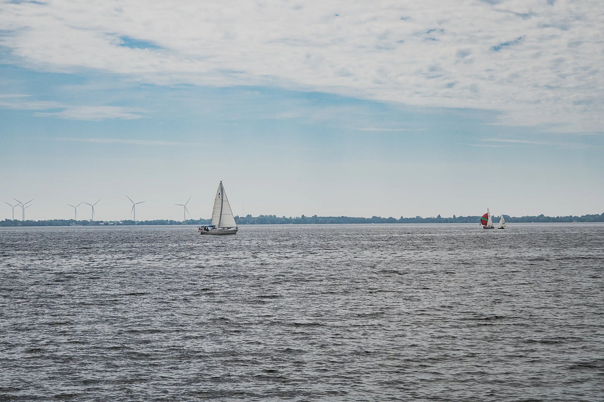 yachts near wind turbines at sea